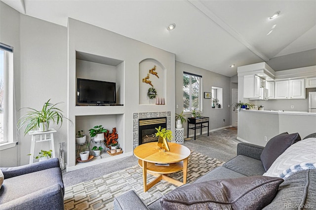 living room featuring lofted ceiling, light colored carpet, baseboards, a tile fireplace, and recessed lighting