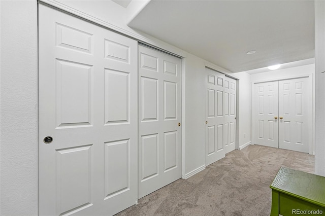 hallway with carpet and baseboards