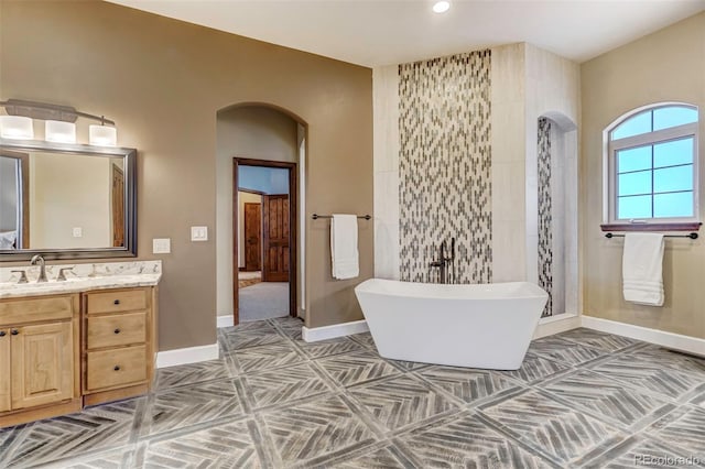 bathroom with vanity and separate shower and tub