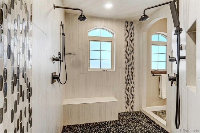 bathroom with plenty of natural light and tiled shower