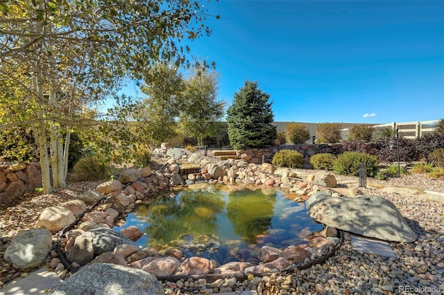 exterior space featuring a garden pond