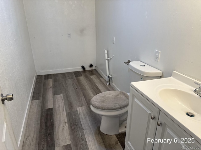 bathroom with hardwood / wood-style flooring, vanity, and toilet