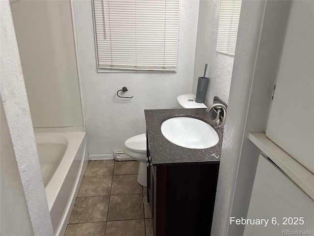 bathroom featuring tile patterned floors, vanity, toilet, and a baseboard heating unit