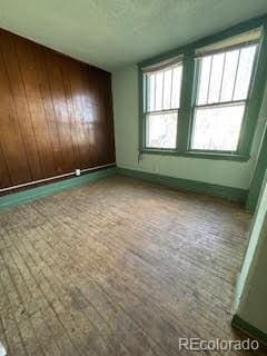 spare room with wooden walls