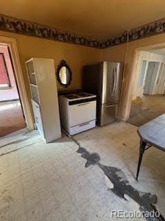 kitchen with white range and stainless steel refrigerator