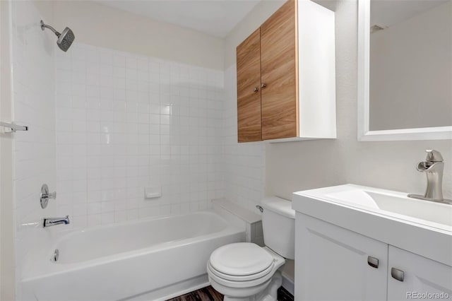 bathroom with bathing tub / shower combination, toilet, and vanity