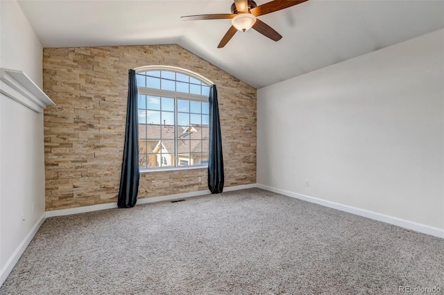 carpeted spare room with lofted ceiling, baseboards, visible vents, and a ceiling fan