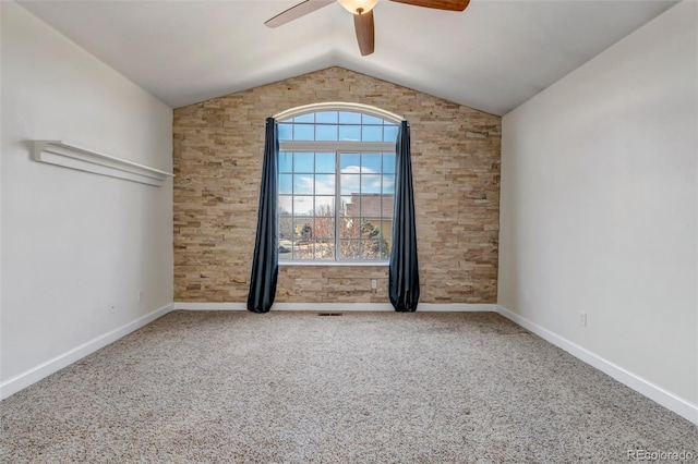 carpeted empty room with lofted ceiling, ceiling fan, and baseboards