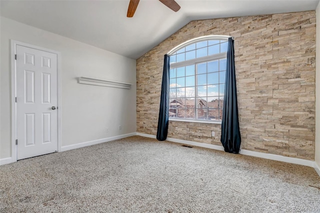 unfurnished room with vaulted ceiling, carpet floors, a ceiling fan, and baseboards