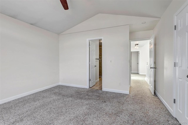 unfurnished bedroom with vaulted ceiling, carpet floors, a ceiling fan, and baseboards