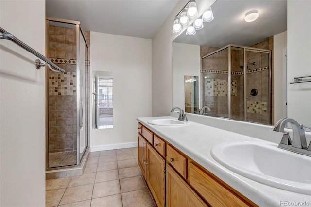 full bath with a stall shower, tile patterned flooring, and a sink