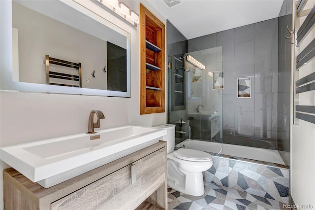 full bath with tiled shower / bath, visible vents, vanity, and toilet