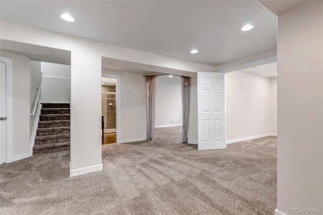 finished basement with carpet floors, baseboards, stairway, and recessed lighting