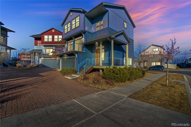 view of front facade featuring decorative driveway and an attached garage