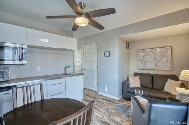 5295 Andes St, Denver, CO 80249 - living area with light wood-style floors, ceiling fan, and baseboards