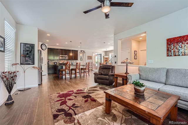 living area featuring recessed lighting, baseboards, light wood-style flooring, and a ceiling fan