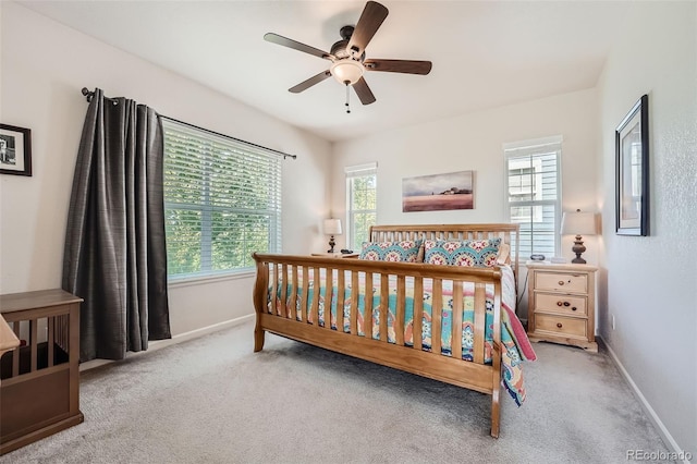 carpeted bedroom featuring ceiling fan and baseboards