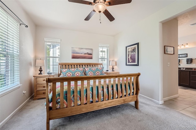 bedroom with baseboards and light carpet