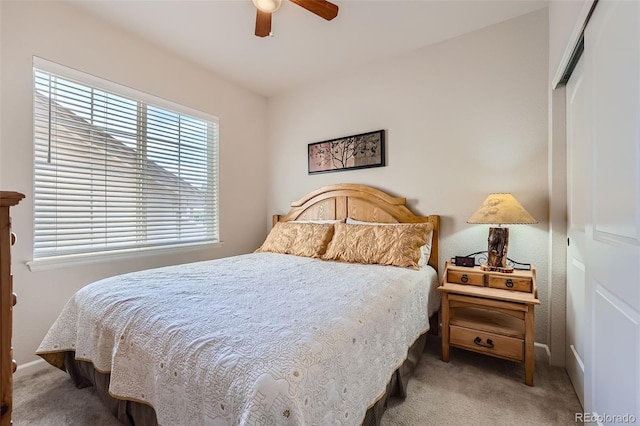 carpeted bedroom featuring a closet and a ceiling fan