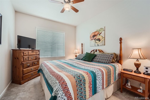 bedroom with ceiling fan, baseboards, and light carpet