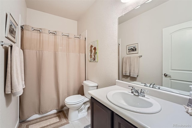 bathroom with tile patterned floors, toilet, vanity, and a shower with curtain