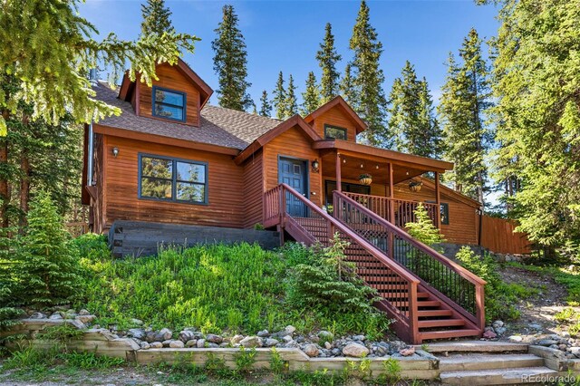 log home with a wooden deck