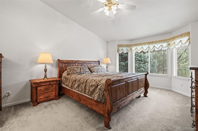 bedroom with light carpet, baseboards, vaulted ceiling, and ceiling fan