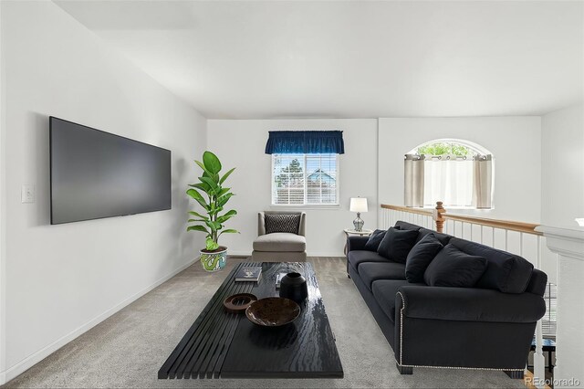 living room featuring plenty of natural light, carpet floors, and baseboards
