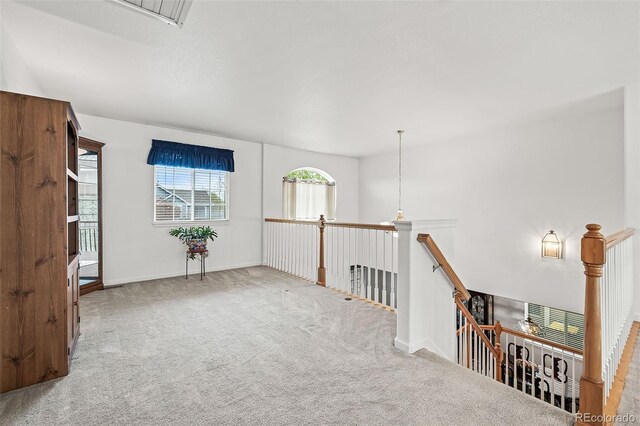 corridor with carpet, an upstairs landing, and baseboards