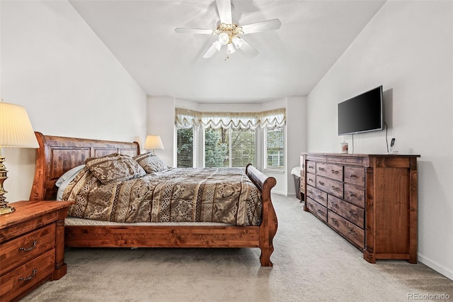 carpeted bedroom with ceiling fan and baseboards