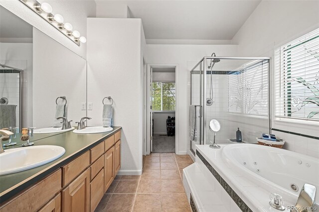 bathroom with a stall shower, a tub with jets, tile patterned floors, double vanity, and baseboards