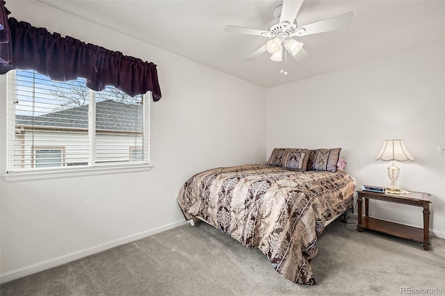 carpeted bedroom featuring baseboards and ceiling fan