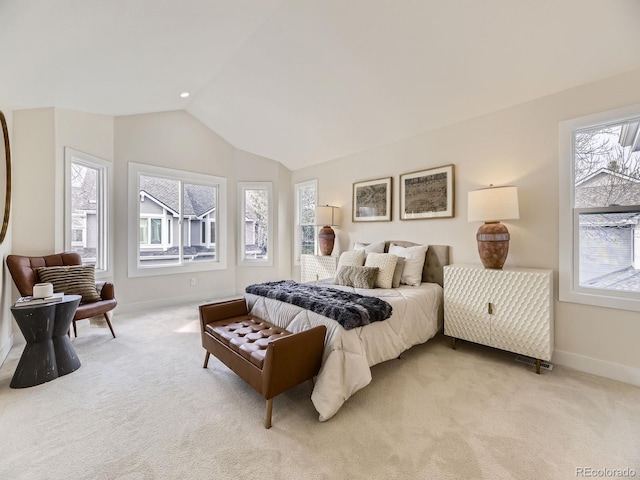 bedroom with light colored carpet and lofted ceiling