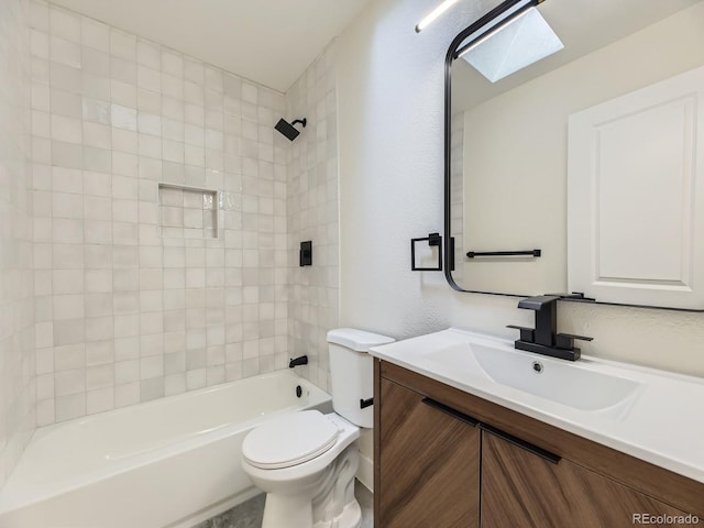 full bathroom featuring vanity, a skylight, toilet, and tiled shower / bath