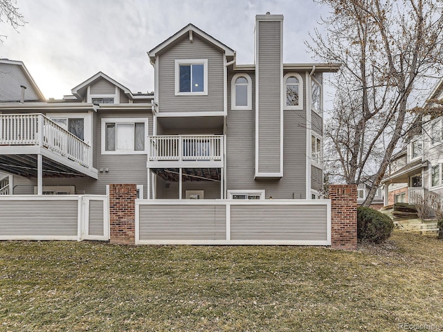 rear view of property with a lawn