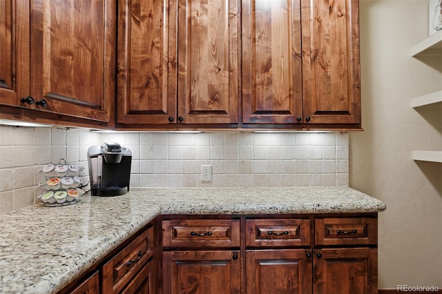 kitchen featuring light stone counters and decorative backsplash