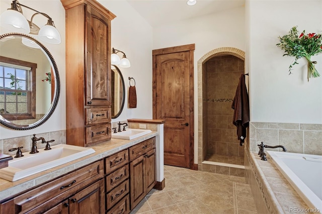 bathroom featuring vanity, tile patterned floors, and separate shower and tub