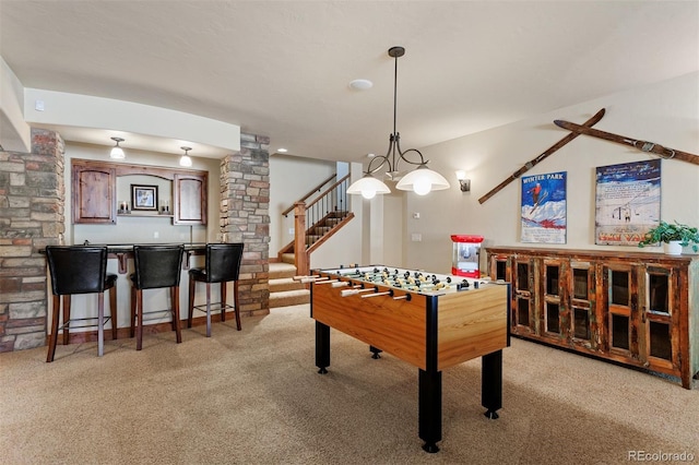 rec room featuring light colored carpet and indoor bar