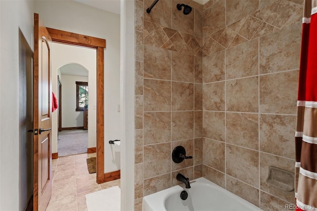 bathroom with tile patterned flooring and shower / tub combo with curtain