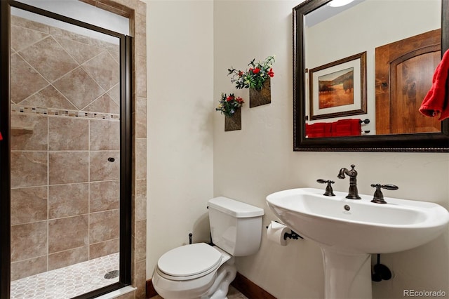 bathroom with sink, toilet, and walk in shower