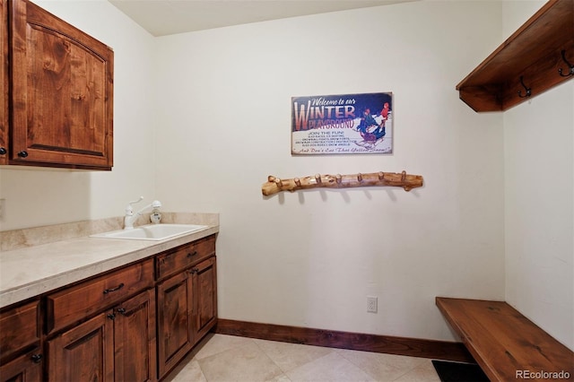 laundry room with sink and light tile patterned floors