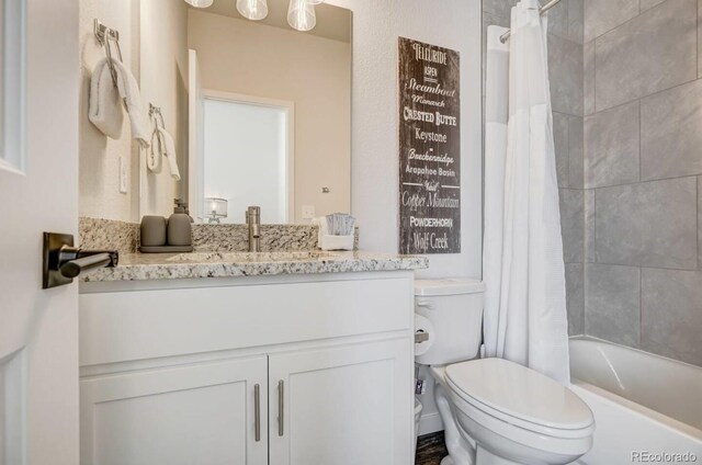 2220 E Ln Salle St Unit 108, Colorado Springs, CO 80909 - bathroom featuring toilet, vanity, and shower / bathtub combination with curtain