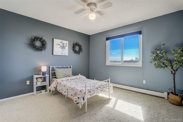 bedroom featuring baseboards, a baseboard heating unit, ceiling fan, and a textured ceiling