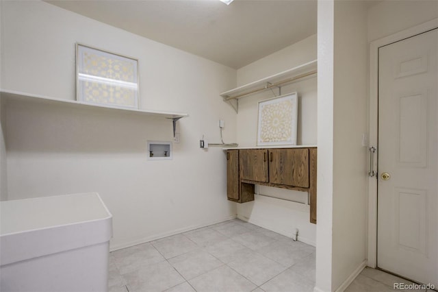 laundry area with light tile patterned floors, laundry area, washer hookup, and baseboards