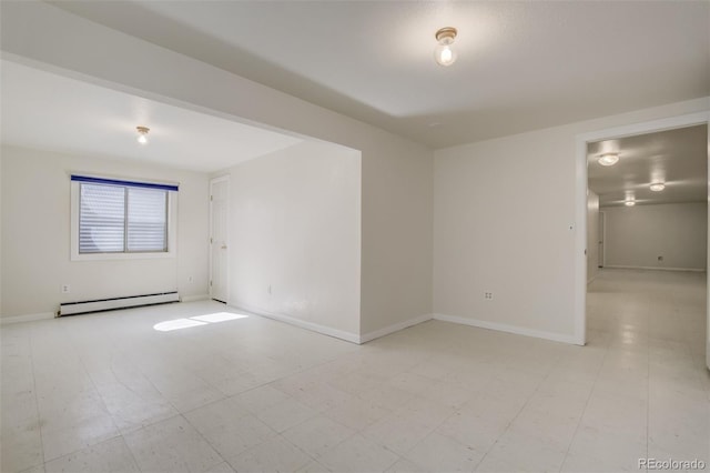 unfurnished room with light floors, baseboard heating, and baseboards