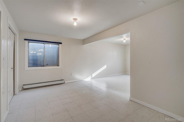 unfurnished room with a baseboard heating unit, light floors, a textured ceiling, and baseboards