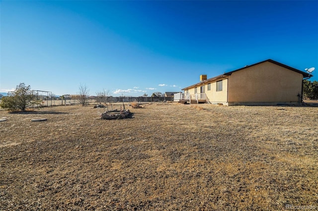 view of yard featuring fence and a wooden deck