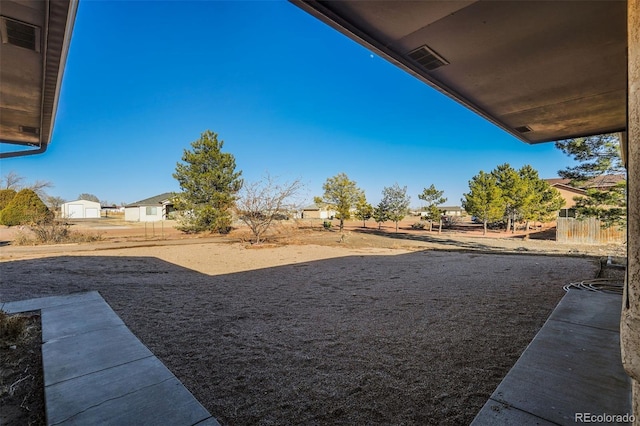 view of yard featuring visible vents and fence