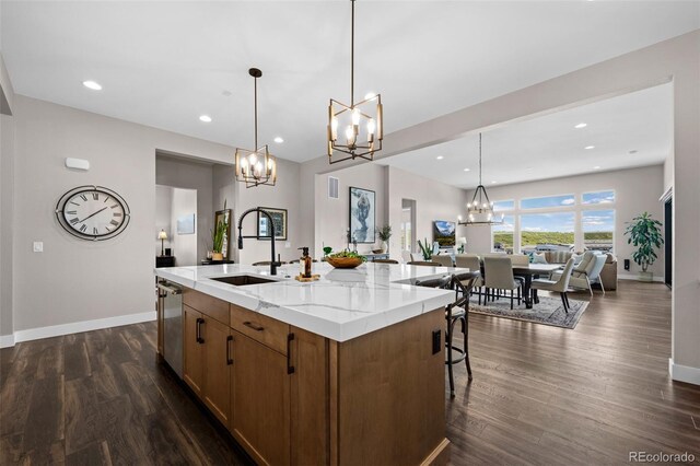 2144 Bellcove Dr, Castle Pines, CO 80108 - kitchen featuring a chandelier, a sink, baseboards, open floor plan, and recessed lighting