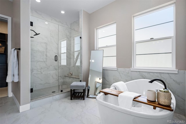 2144 Bellcove Dr, Castle Pines, CO 80108 - bathroom with a shower stall, a soaking tub, marble finish floors, recessed lighting, and baseboards